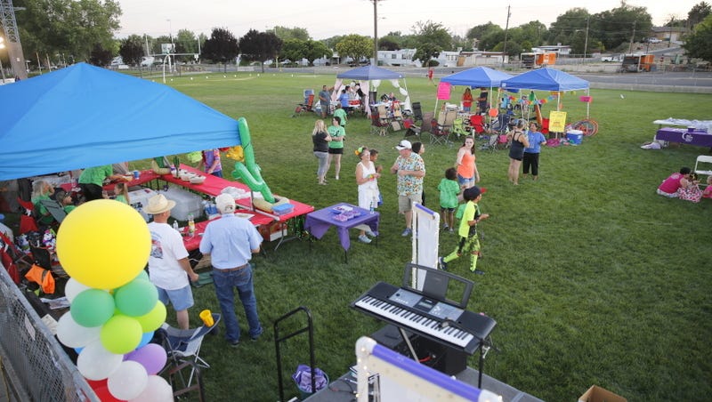 Participants in Saturday's Relay for Life mingle on the football field at the Boys & Girls Clubs of Farmington.