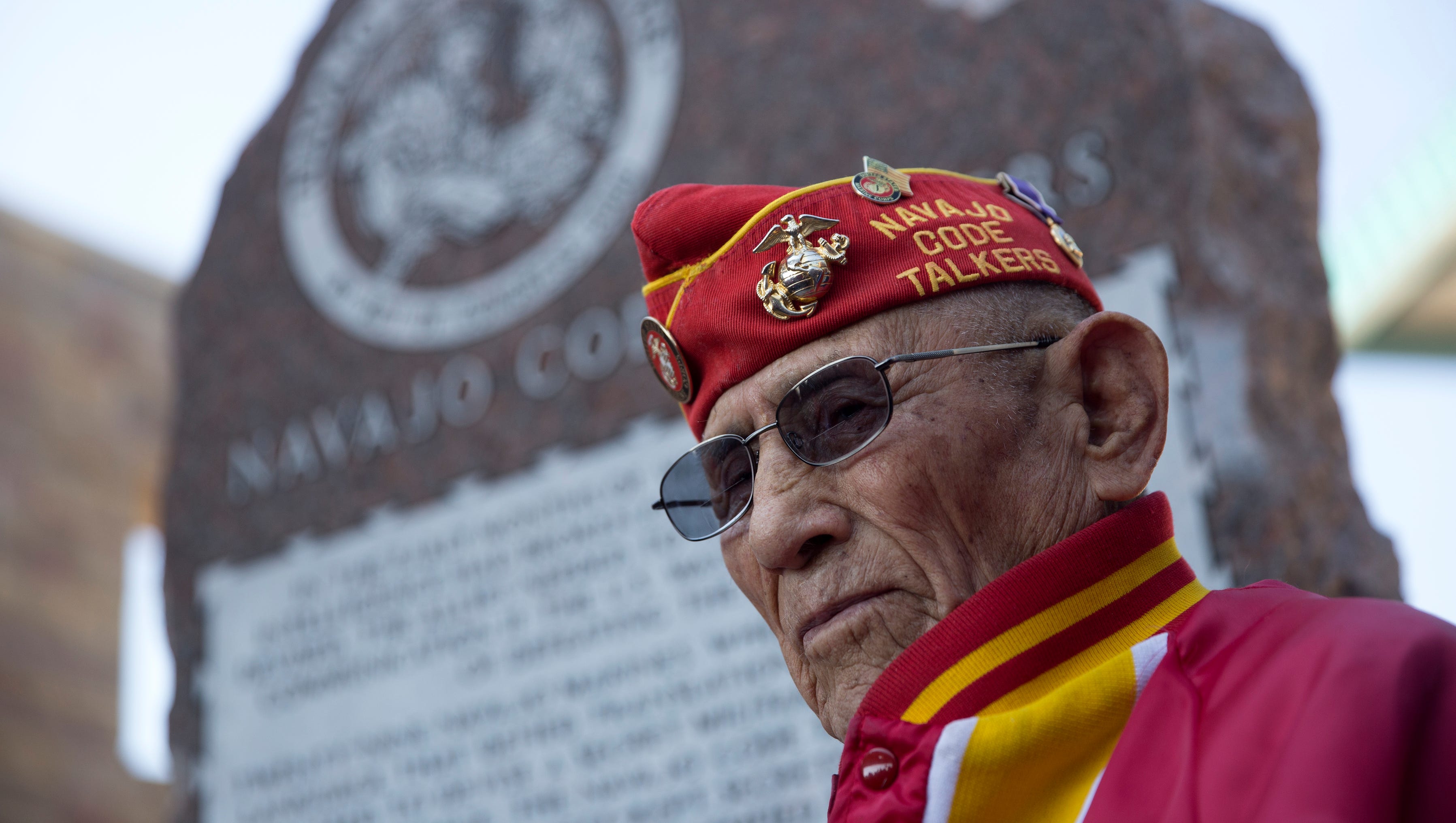 Navajo Code Talker John Kinsel Sr. stands next to a memorial dedicated to the Navajo Code Talkers Friday during an unveiling ceremony at the San Juan County Administration Offices in Aztec.
