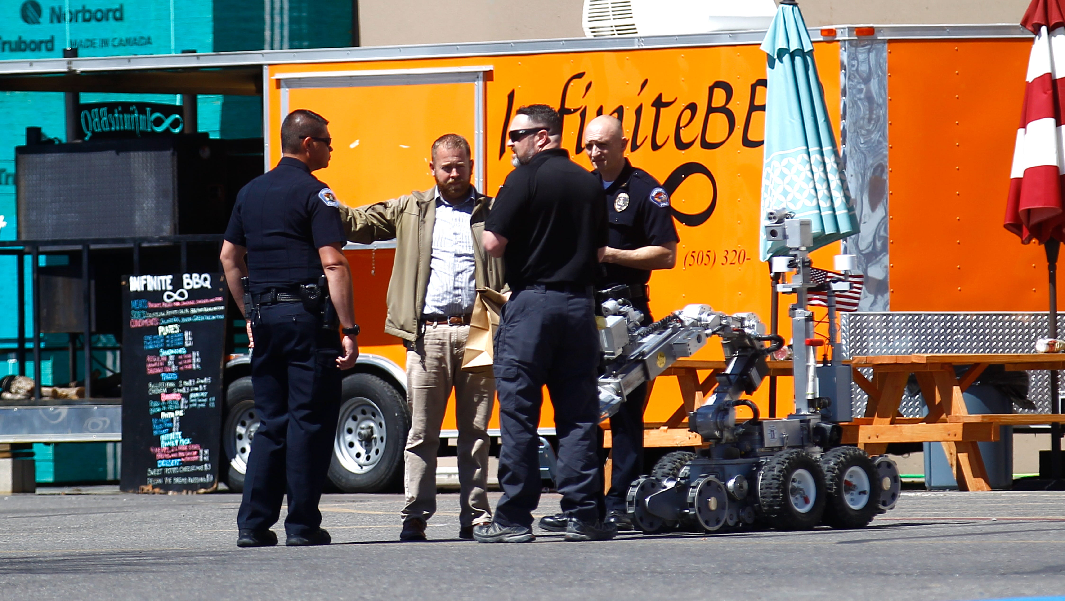 Farmington police officers investigate a suspicious package on Monday at Lowe's Home Improvement in Farmington.
