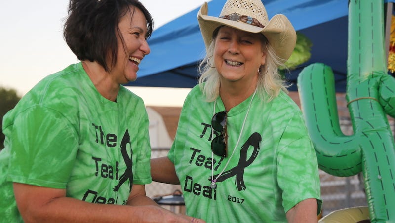 Mike Easterling/The Daily Times Kelly Dupler, left, and Sheridy Walker share a laugh during Saturday's Relay for Life at the Boys & Girls Clubs of Farmington football field.