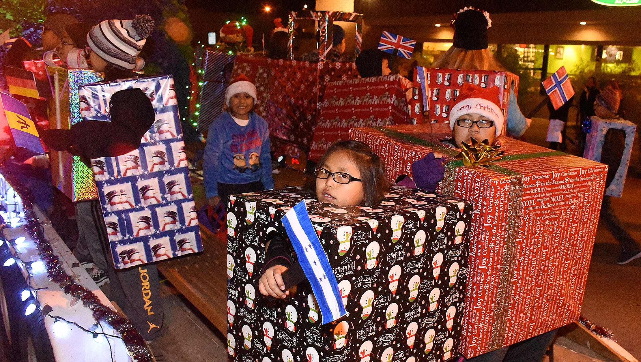 Tekeria Beyale, 11, and other students from Apache Elementary School take part in the annual Christmas Parade sponsored by the Farmington Chamber of Commerce on Thursday Dec. 1, 2016, on Main Street.