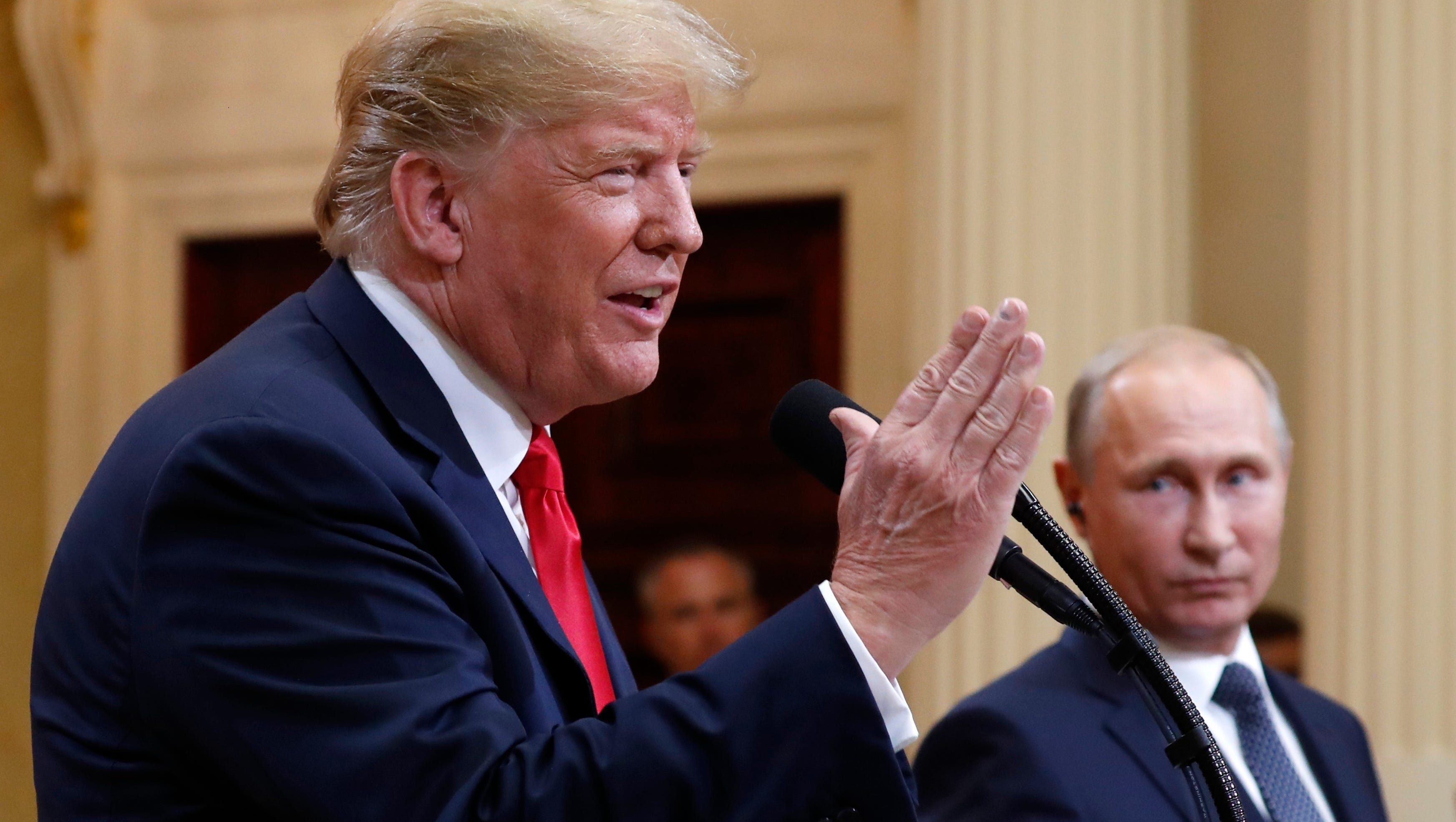 U.S. President Donald Trump speaks with Russian President Vladimir Putin during a press conference after their meeting at the Presidential Palace in Helsinki, Finland, Monday, July 16, 2018.