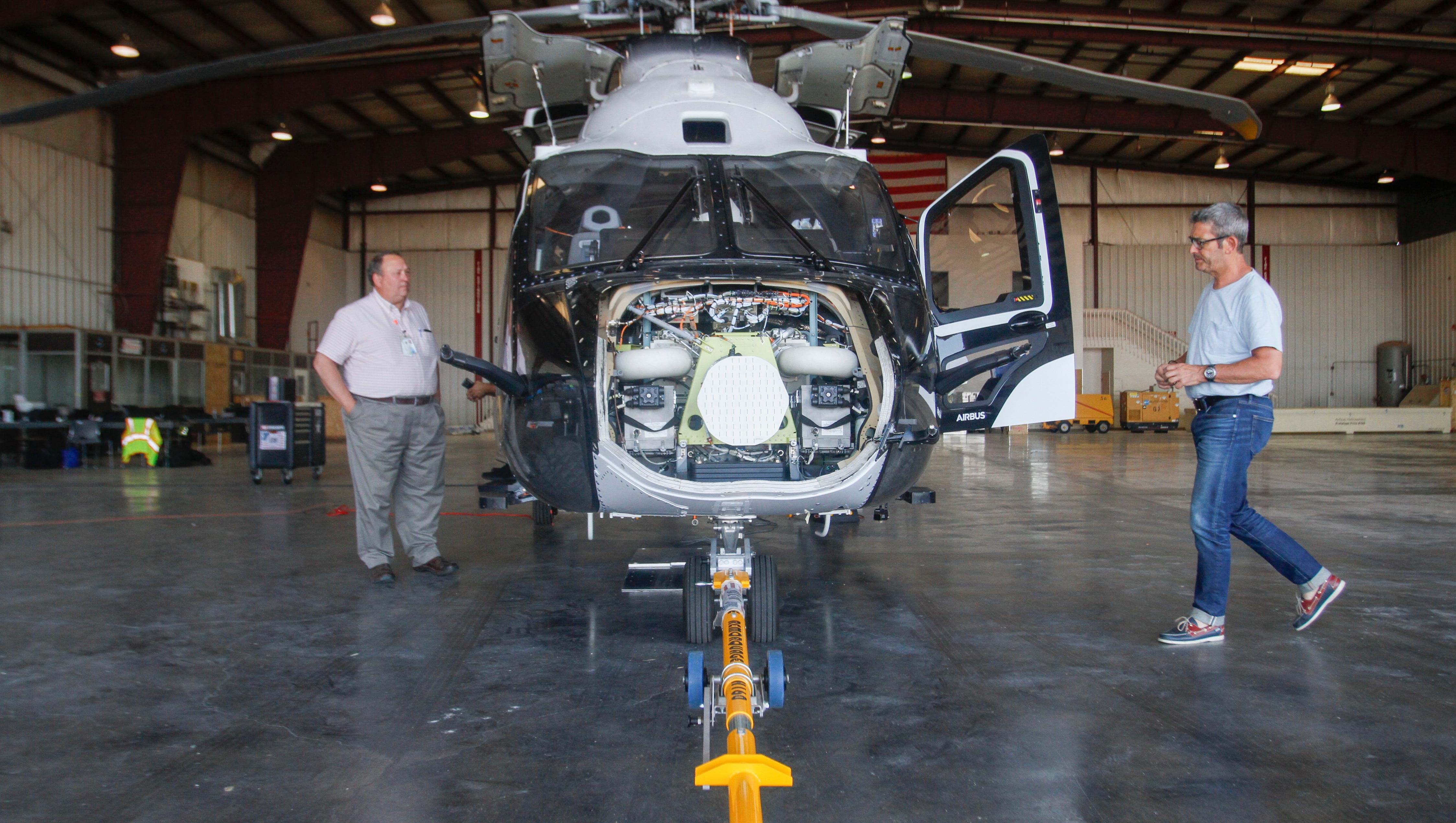 Mike Lewis, airport manager for the Four Corners Regional Airport, left, looks over the Airbus H160 helicopter as Pascal Jervaise, a support analyst for Airbus Helicopters, works Tuesday at the Four Corners Regional Airport in Farmington.