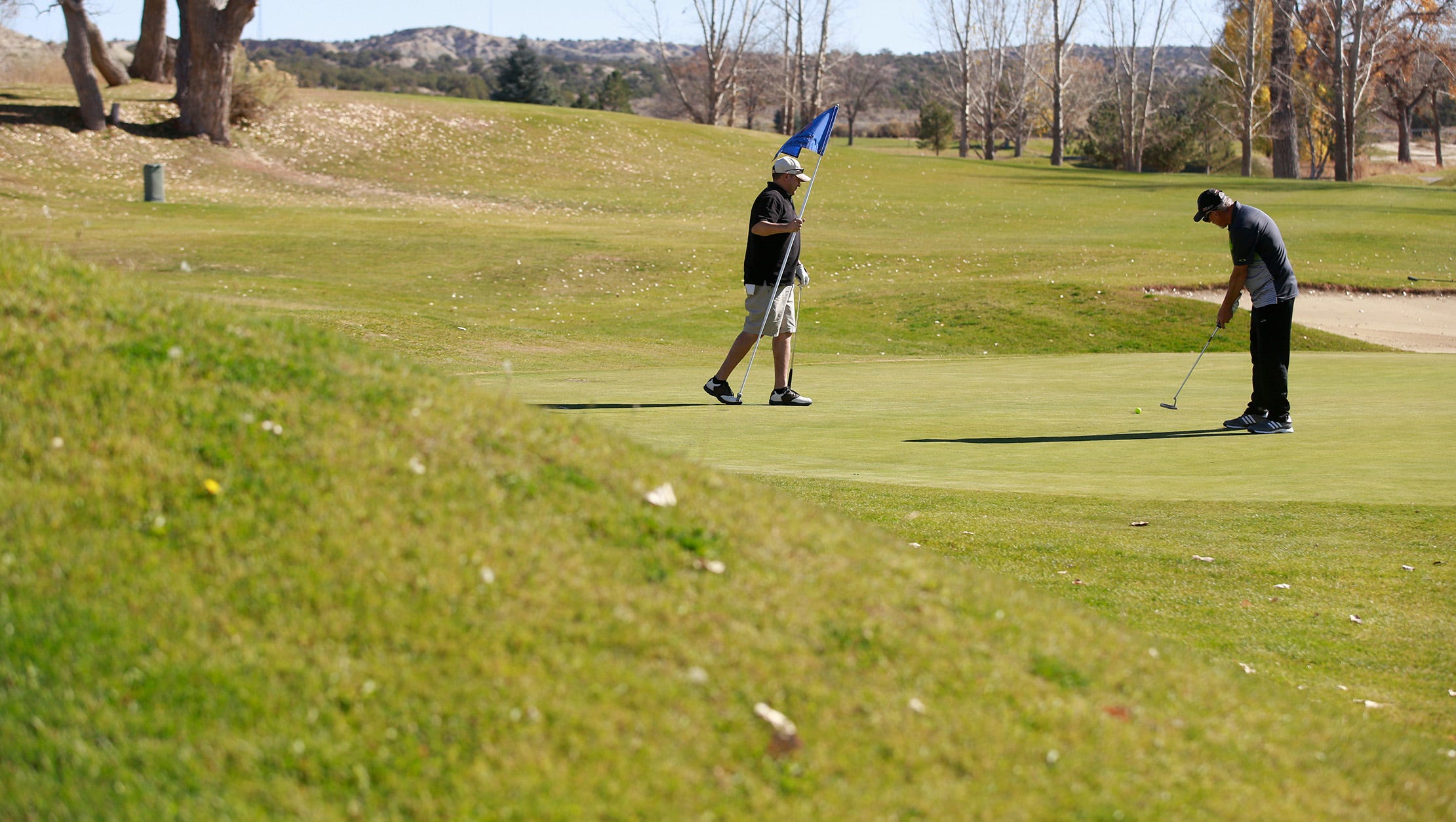A pair plays golf on Nov. 11 at the Aztec Municipal Golf Course.
