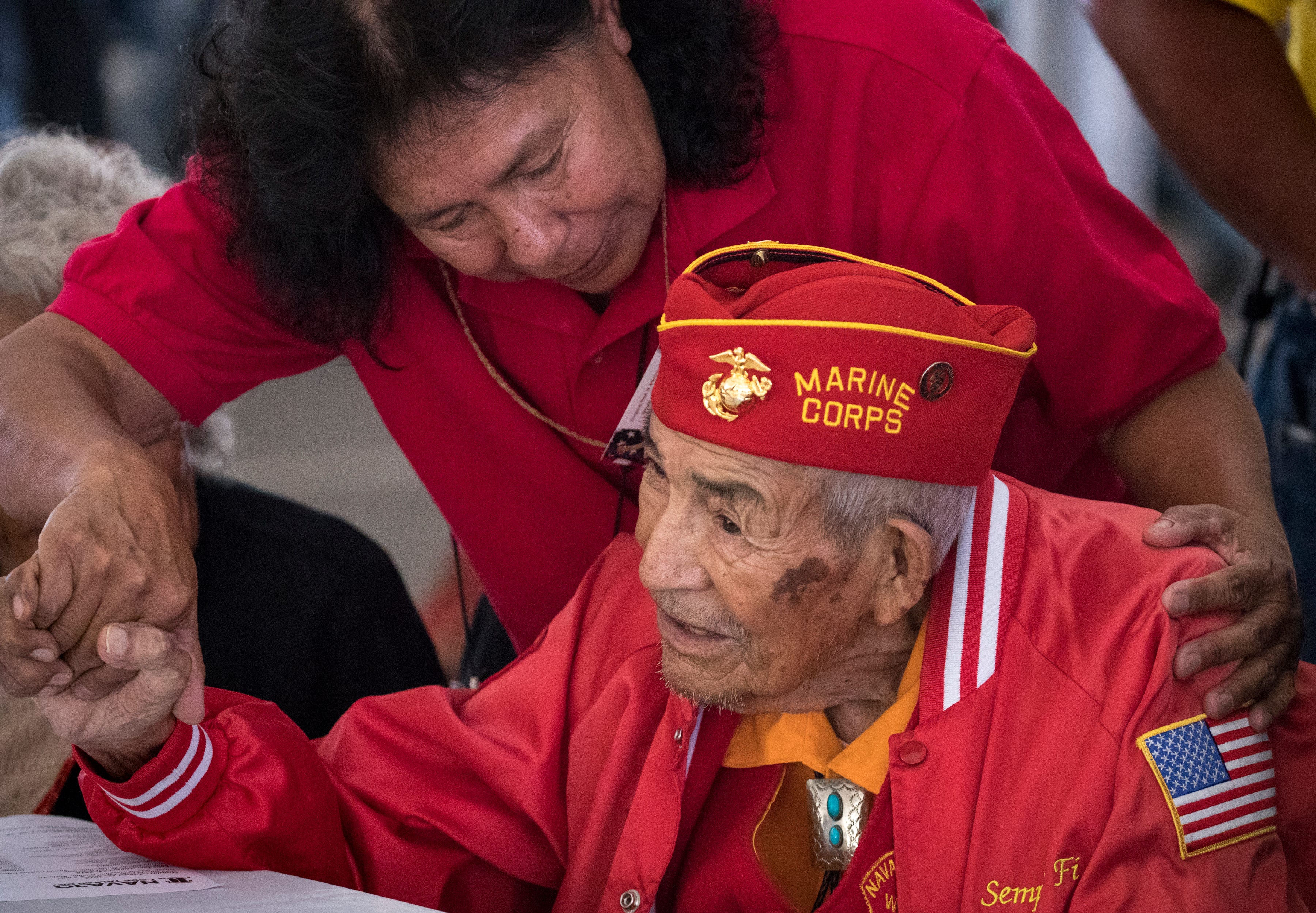 Navajo Code Talker Alfred Newman is greeted by granddaughter Yvonne Tso during the Navajo Nation Code Talkers Day ceremony Aug. 14, 2018, at the Veterans Memorial Park in Window Rock.