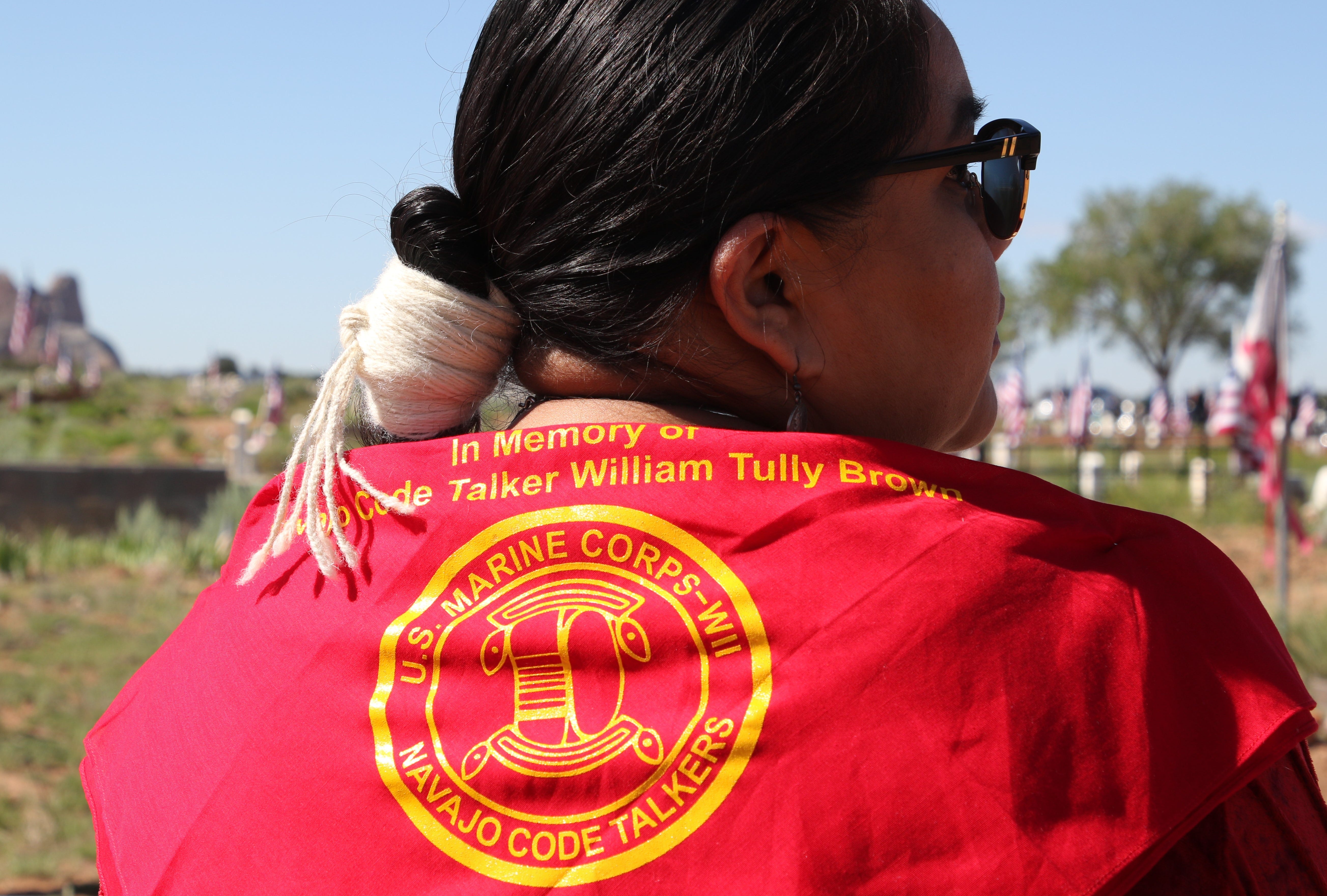 Nikki Tully wears a red scarf family members received at the June 6 memorial service for Navajo Code Talker William Tully Brown Sr. at the Fort Defiance Veterans Cemetery in Fort Defiance, Ariz.