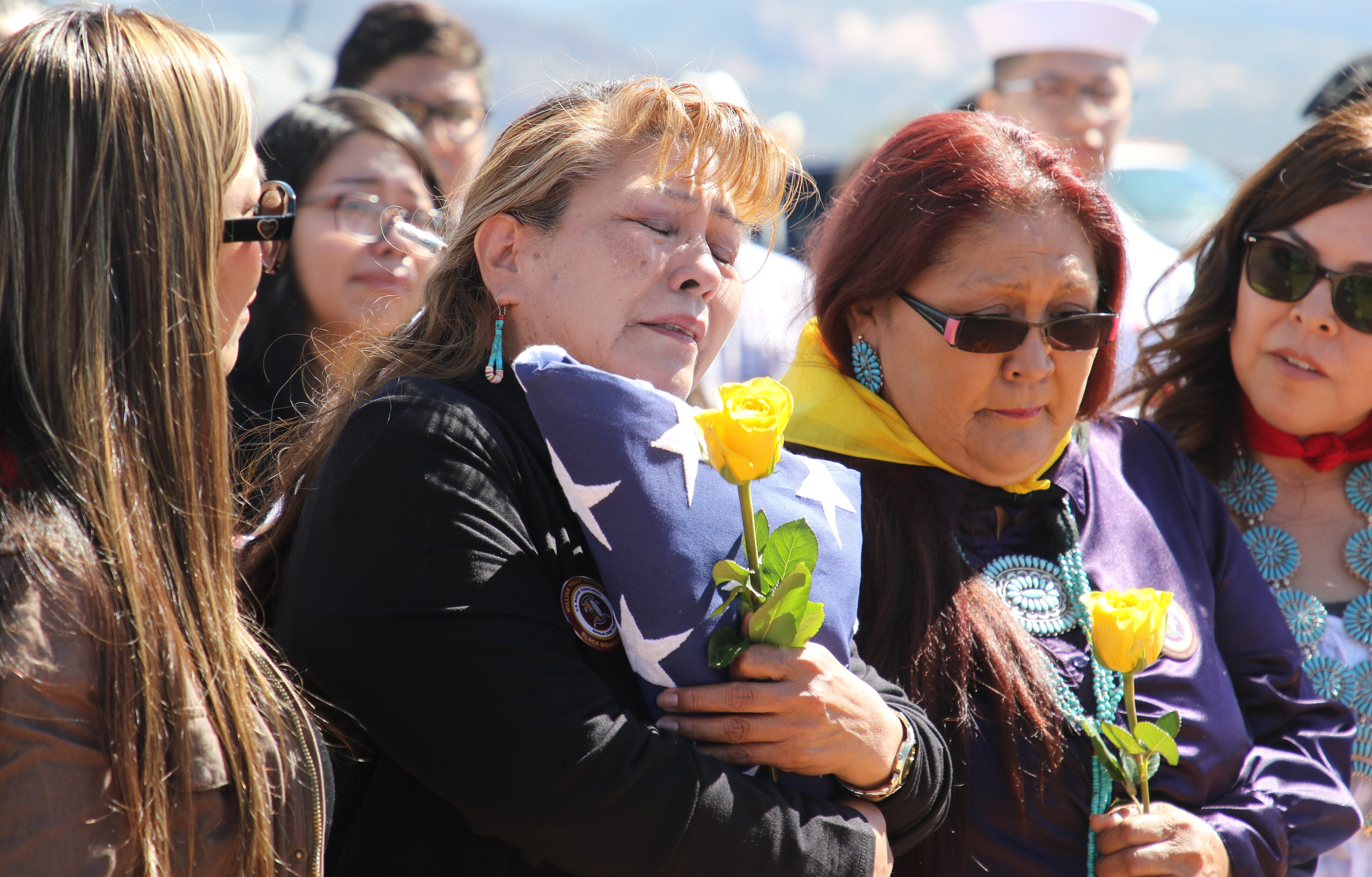 Vee F. Browne-Yellowhair embraces the burial flag for her father, Navajo Code Talker William Tully Brown, during his memorial service on June 6 at the Fort Defiance Veterans Cemetery in Fort Defiance, Ariz.