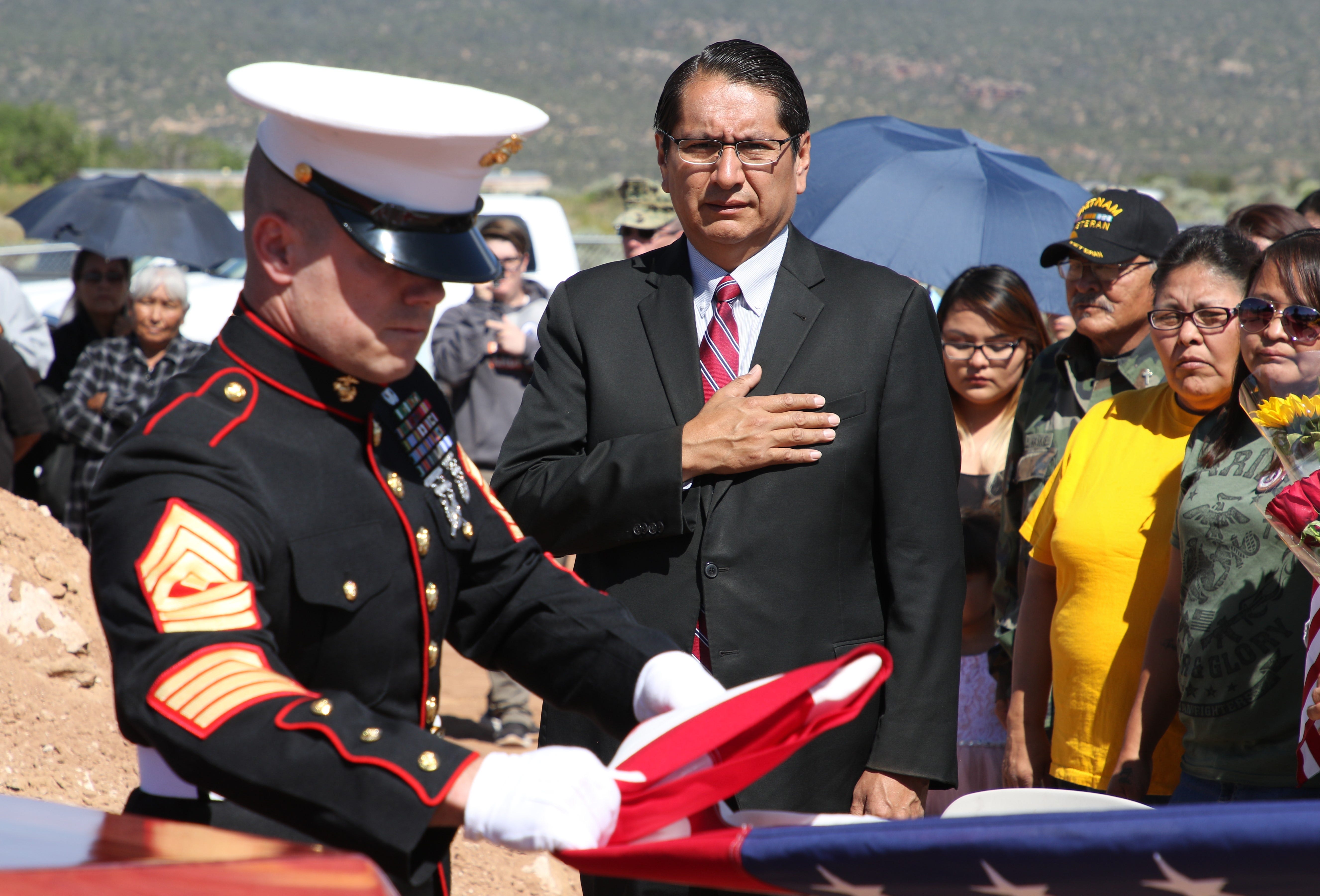 Navajo Nation President Jonathan Nez watches a U.S. Marine Corps member fold the burial flag for Navajo Code Talker William Tully Brown Sr. on June 6 at the Fort Defiance Veterans Cemetery in Fort Defiance, Ariz.