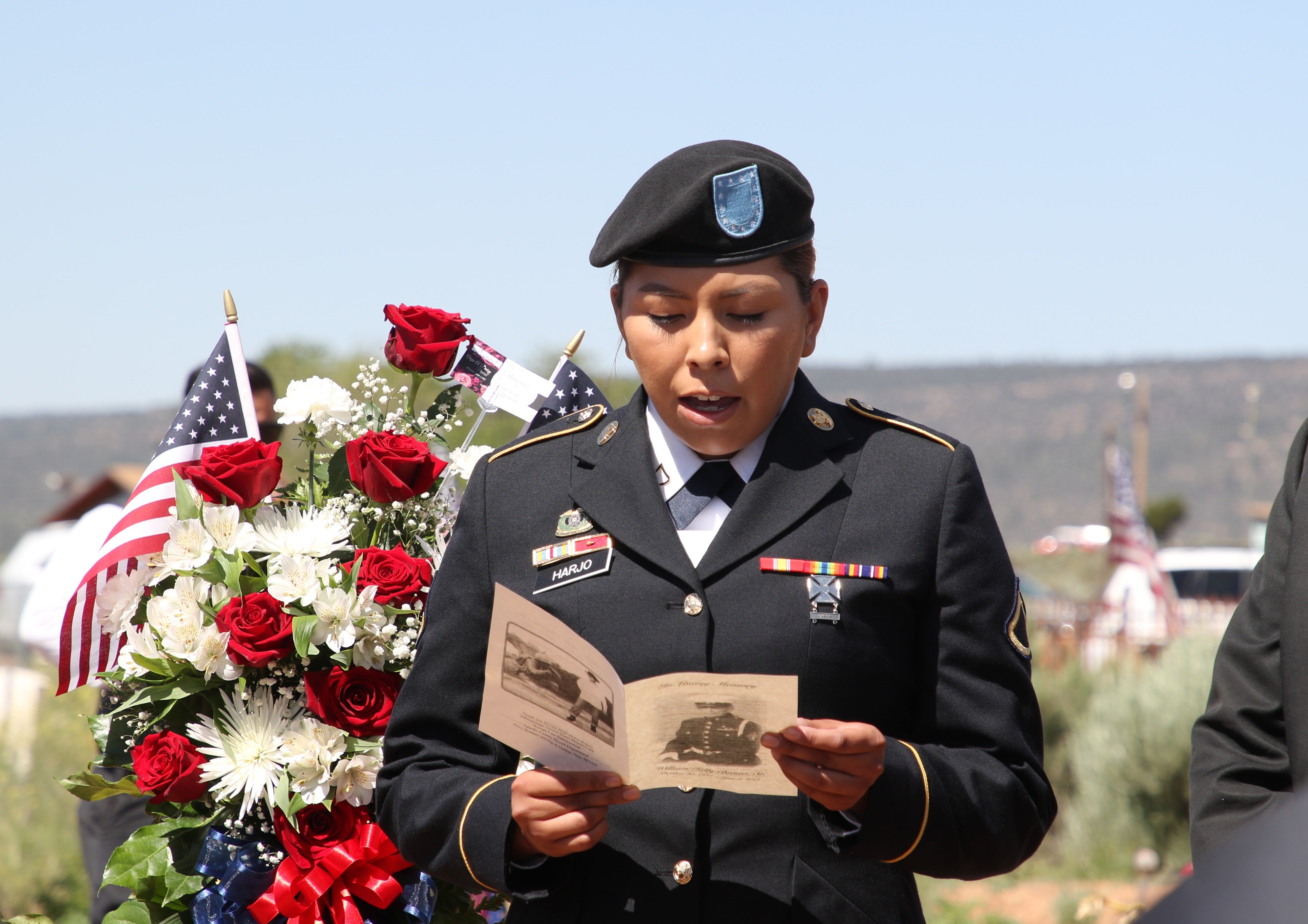 A great-granddaughter of Navajo Code Talker William Tully Brown Sr. reads a poem during the June 6 memorial service at the Fort Defiance Veterans Cemetery in Fort Defiance, Ariz.