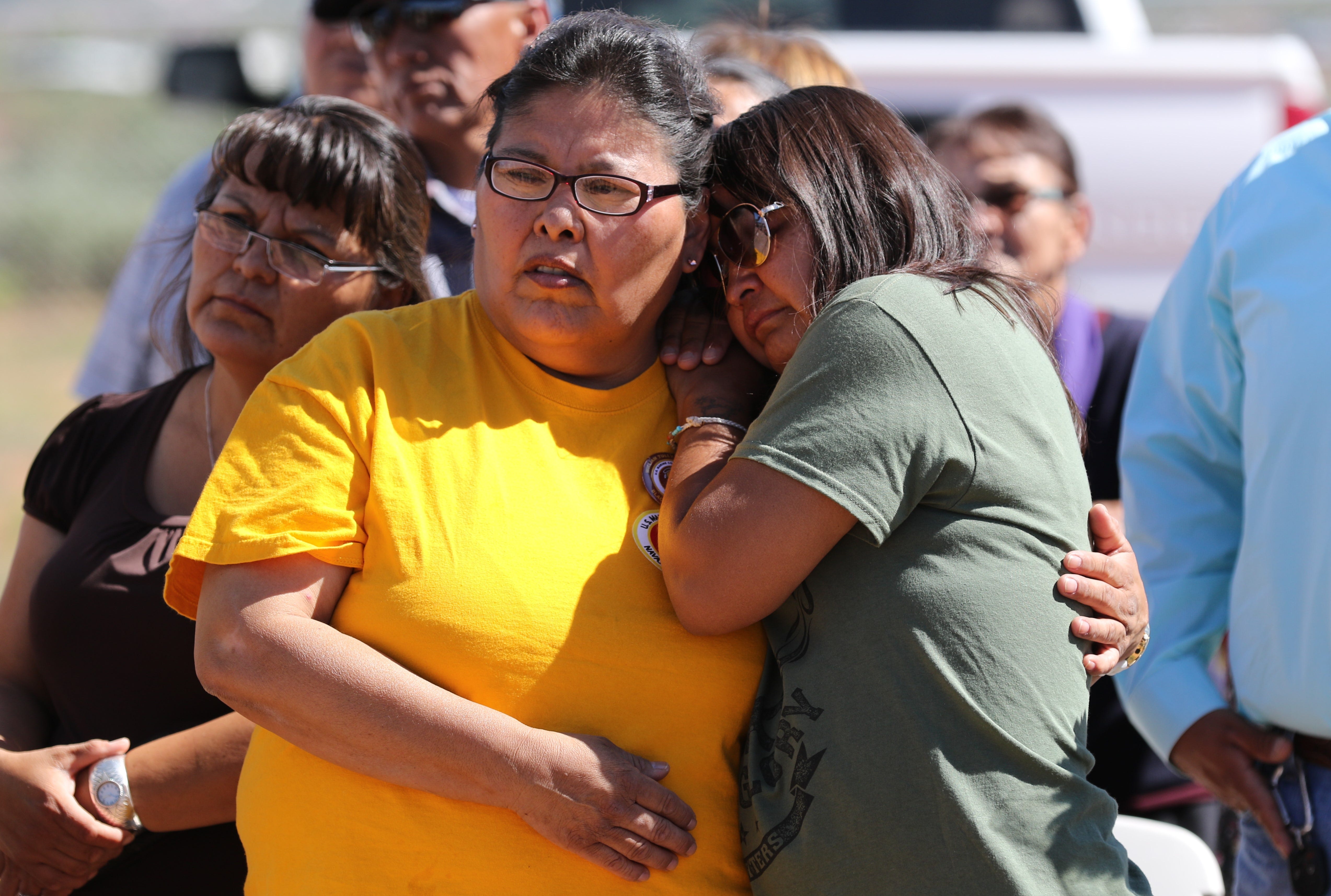 Pauline Francis, left, comforts Raquel Brown during a memorial service for Navajo Code Talker William Tully Brown Sr. on June 6 at the Fort Defiance Veterans Cemetery in Fort Defiance, Ariz. Raquel is one of Brown's daughters.