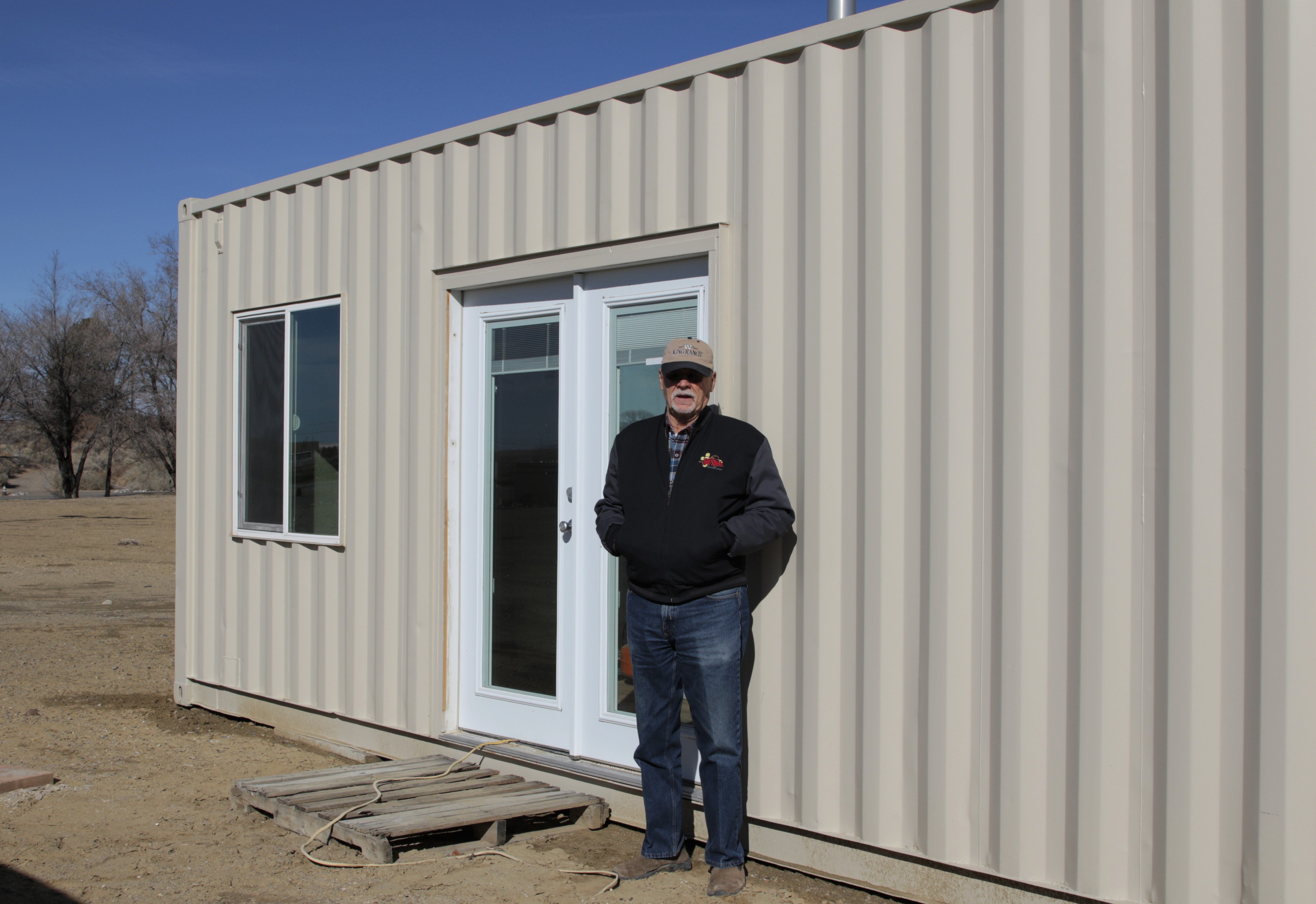 Larry Waldroup stands outside a shipping container house, Thursday, Jan. 23, 2020, in Kirtland.