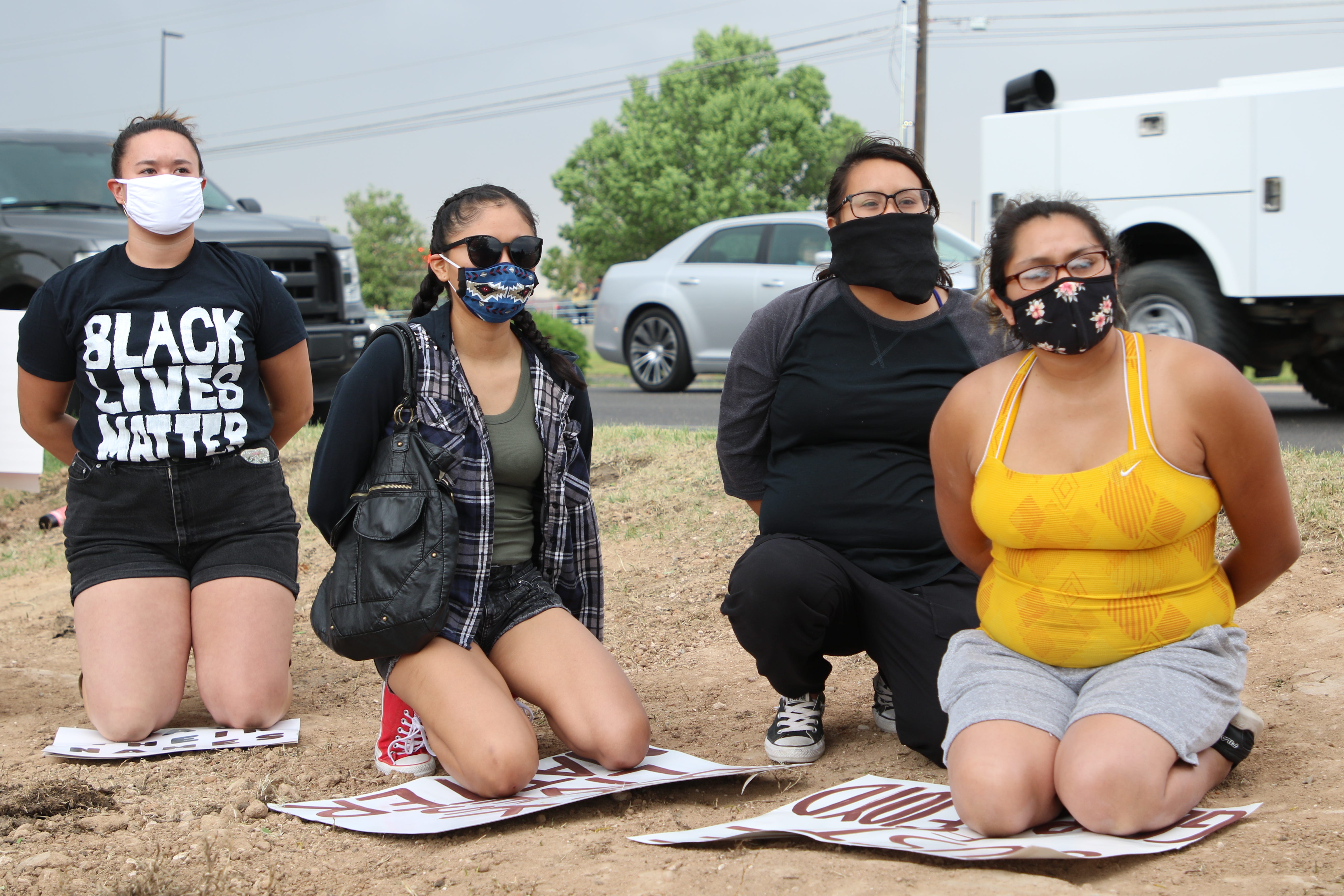 Participants take a knee in solidarity at a protest on June 1 near the Animas Valley Mall in Farmington that called for justice in George Floyd's death in Minneapolis.