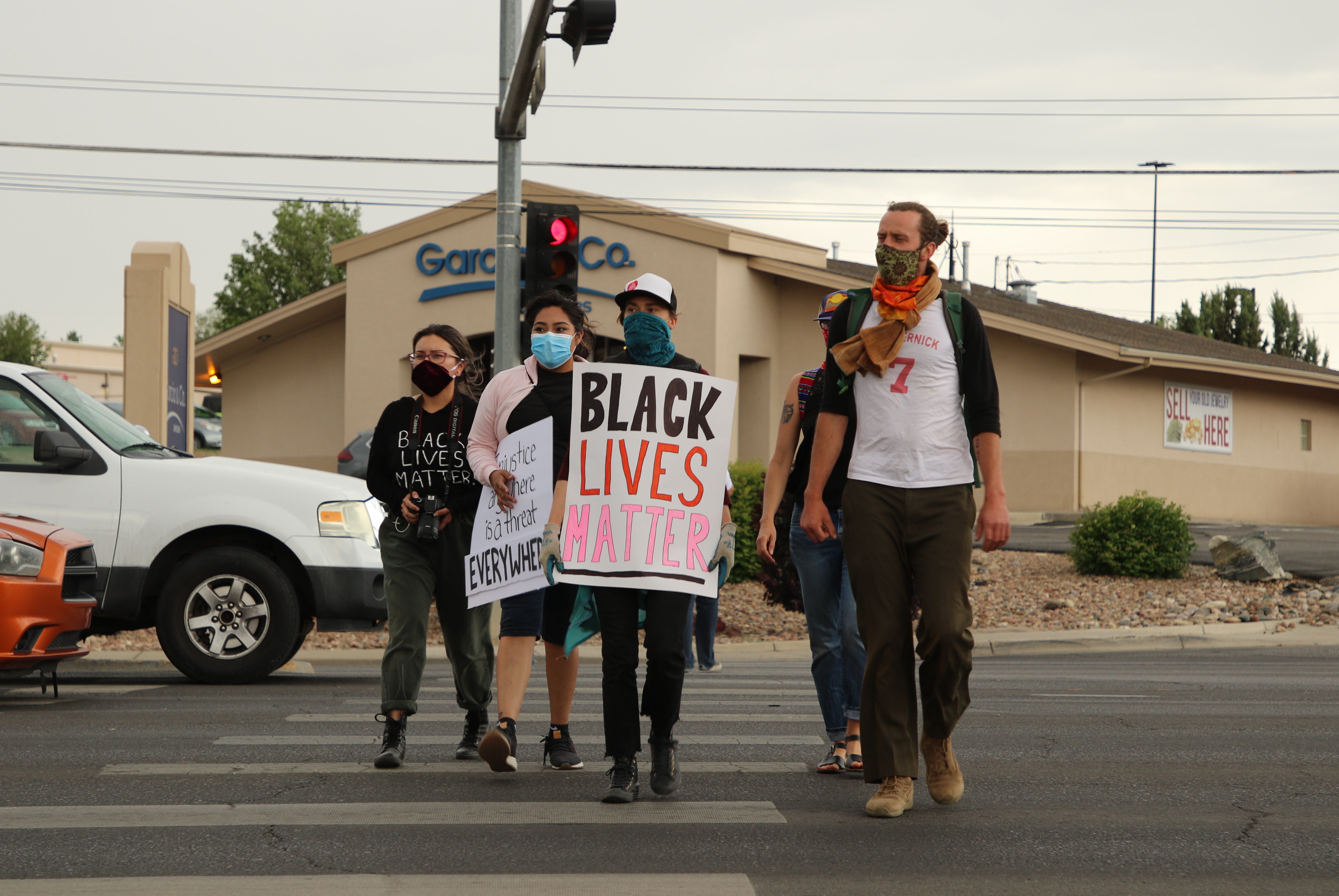 Community members cross Main Street in Farmington to join a protest on June 1 near the Animas Valley Mall that called for justice in George Floyd's death in Minneapolis.