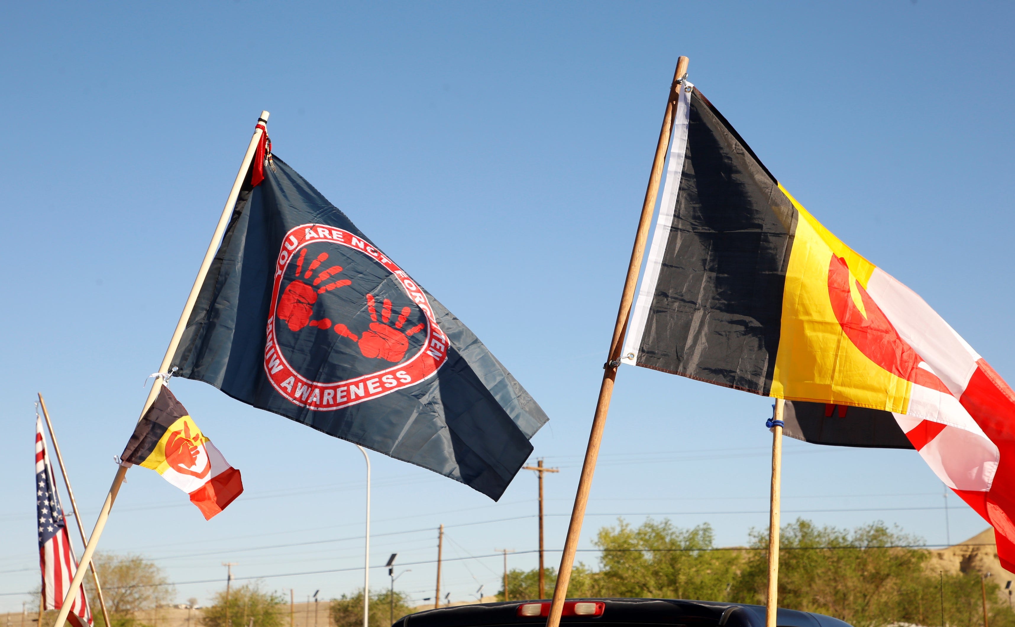 Participants carried flags for Missing and Murdered Indigenous Women and for the American Indian Movement during the MMIW memorial honor walk on May 5 in Shiprock.