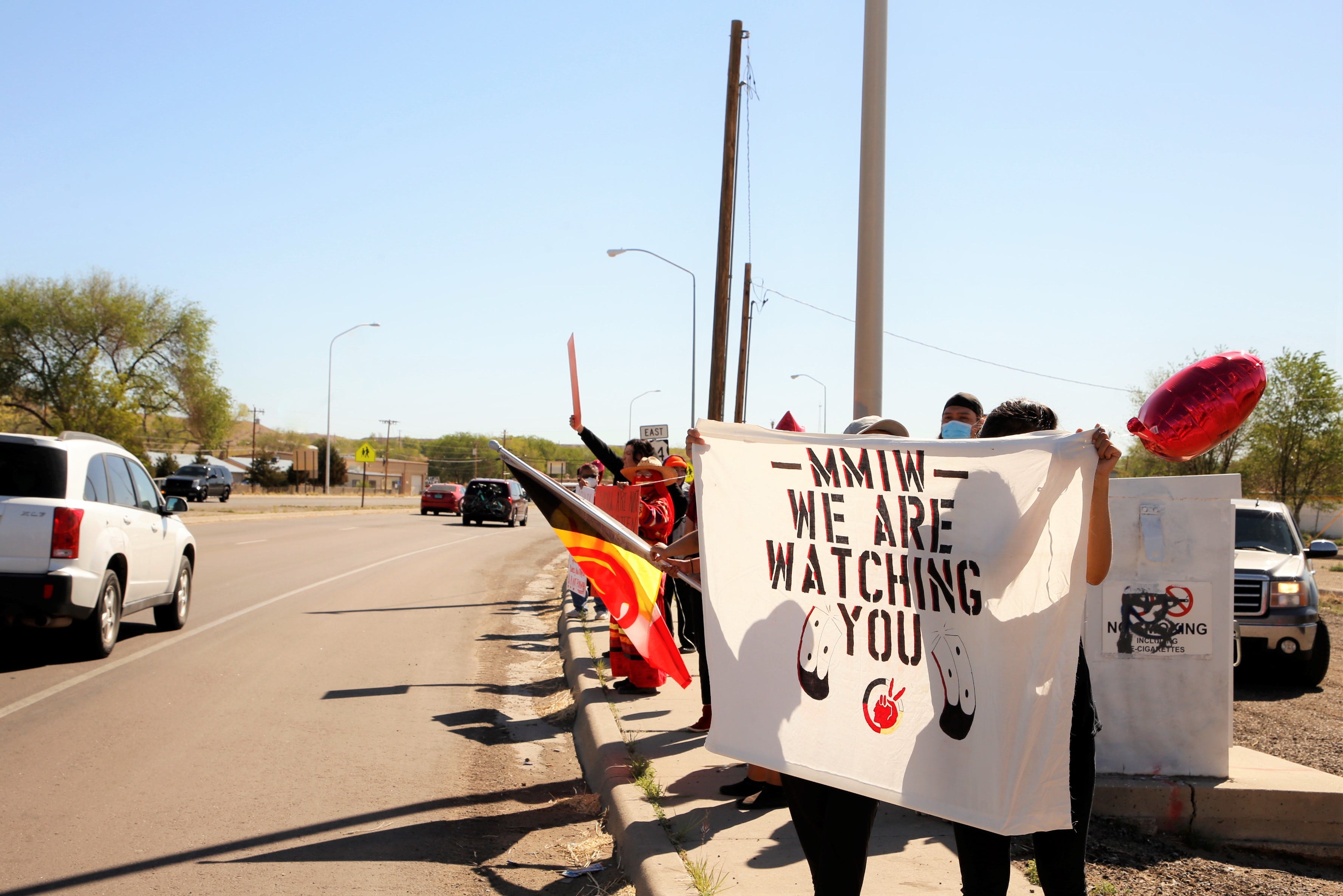 Missing and Murdered Indigenous Women Memorial Honor Walk participants stand on May 5 at the intersection of U.S. highways 64 and 491 in Shiprock.
